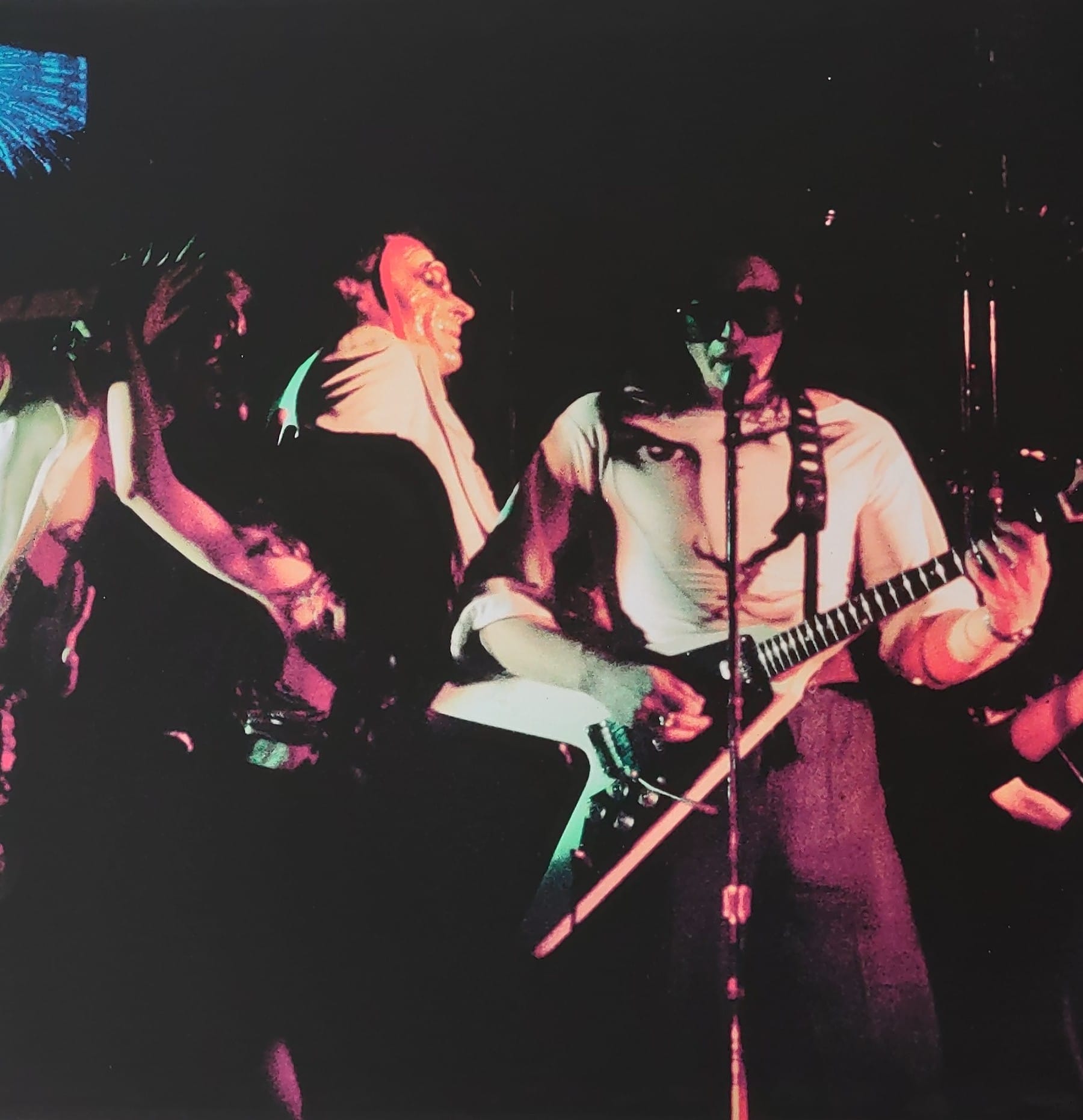 Bill Spooner on guitar under colorful stage lights, early Tubes live shot in color