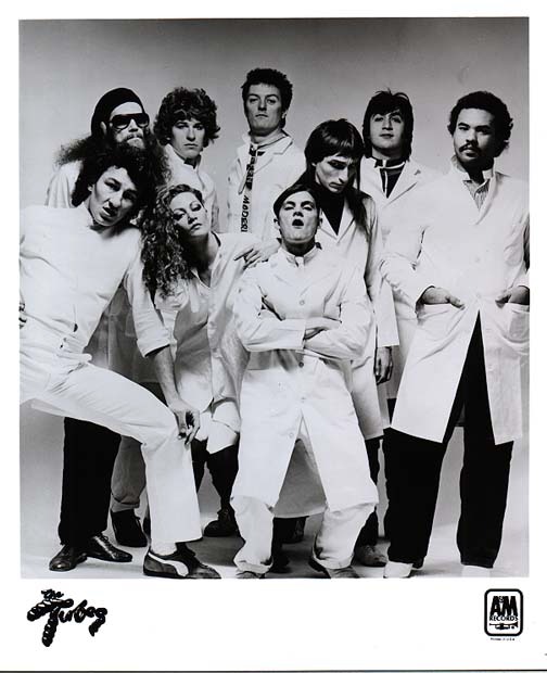 A&M Records promotional photo — band and dancers in white