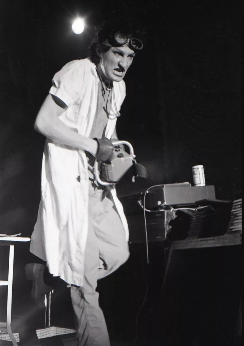 Dr. Strangekiss on stage with a chainsaw