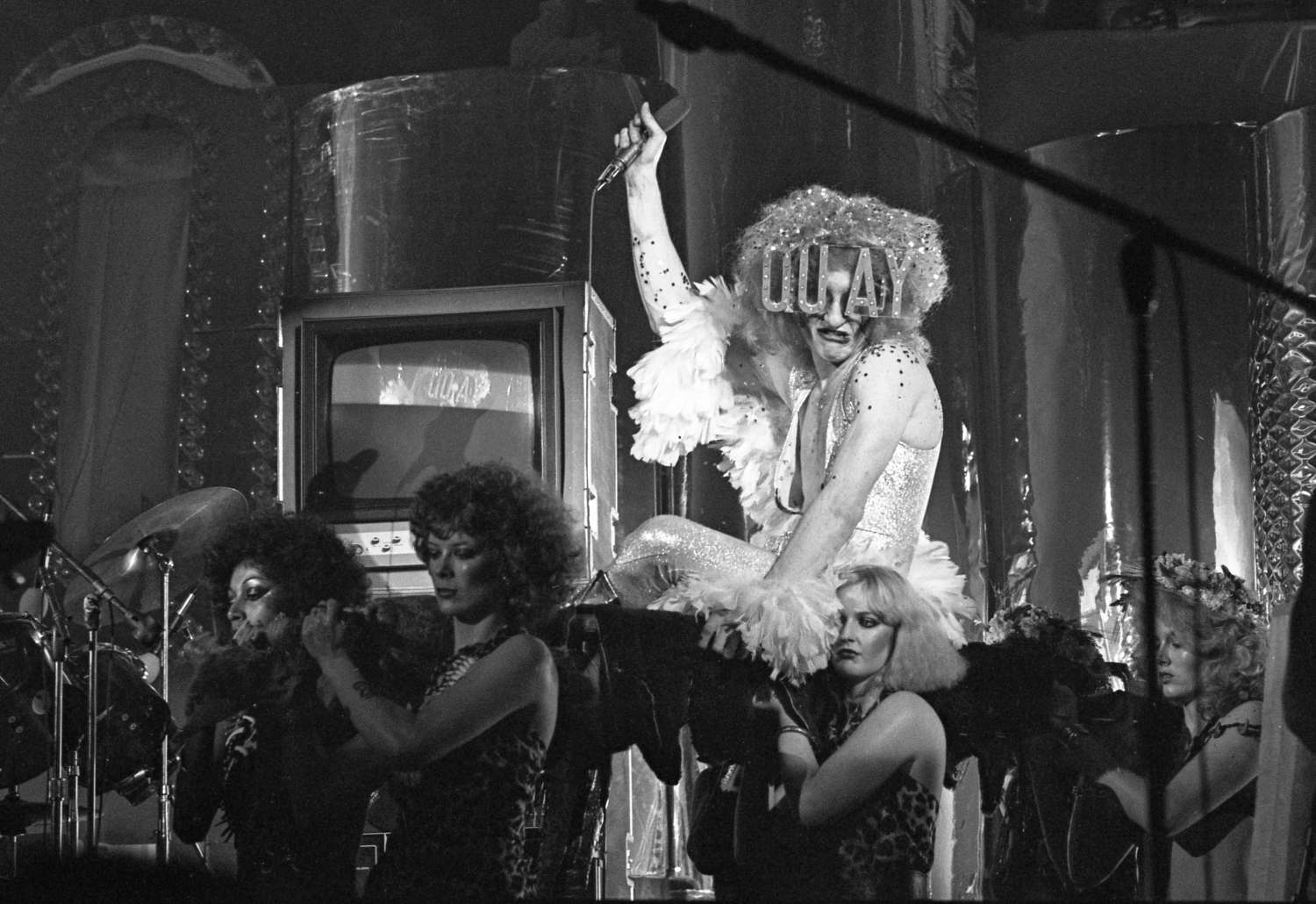 Quay Lewd atop a stack of televisions